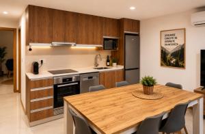 a kitchen with a wooden table and a dining room at Casa Machado in Cabeceiras de Basto