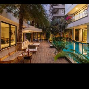 a large house with a swimming pool and a patio at amarzito villa in Dona Paula