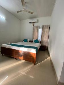 a bedroom with a large bed in a room at villas alleppey in Alleppey