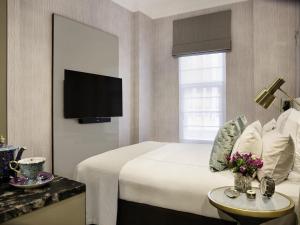 a hotel room with a bed and a tv at Fable Auckland, MGallery in Auckland