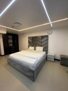 a bedroom with a large bed in a room at Teddy apartment in Lagos