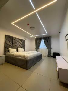 a bedroom with a bed in a room with avisor at Teddy apartment in Lagos