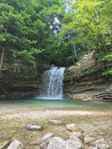 a waterfall in the middle of a river at Villa Okatse in Zeda-Gordi