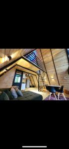a room with a loft with a staircase and a chair at Villa cottage D3 in Zeda Ulianovka