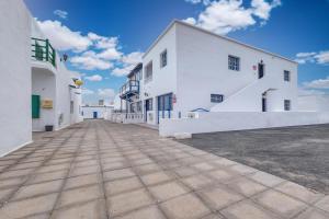 an empty street in front of a white building at Casa Suso y Casa Margarita- Orzola Coastal Retreat by LVH in Órzola