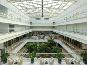 an image of a large building with a cafeteria at Rixos Premium Dubrovnik in Dubrovnik