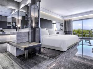 a bedroom with a large bed and a bathroom at Rixos Premium Belek - The Land of Legends Access in Belek