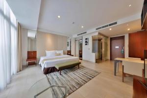 a hotel room with a bed and a desk at SILA Urban Living in Ho Chi Minh City