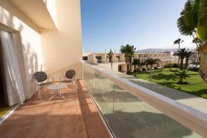a balcony with chairs and a view of the ocean at Hotel Drago Park by Pierre & Vacances in Costa Calma