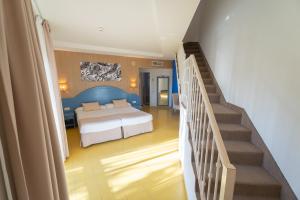 a bedroom with a bed and a staircase with a stair case at Hotel Drago Park by Pierre & Vacances in Costa Calma