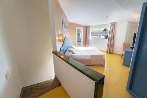 a hotel room with a bed and a balcony at Hotel Drago Park by Pierre & Vacances in Costa Calma