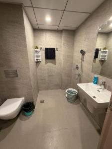 a bathroom with a toilet and a sink at M R ComfortHeaven in Greater Noida