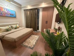 a bedroom with a bed and a living room at M R ComfortHeaven in Greater Noida