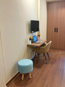 a room with a desk with a laptop and a stool at M R ComfortHeaven in Greater Noida