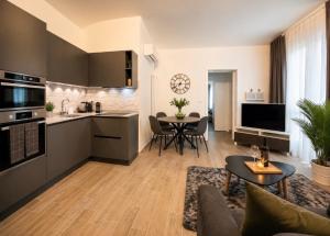 a kitchen and a living room with a table at Apartment Vitale in Bologna
