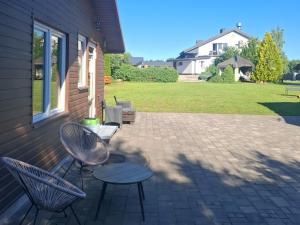 a patio with two chairs and a table at domek 3 osoobowy in Augustów