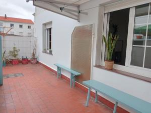 a patio with a blue bench and a window at Casa Oskar in Avilés