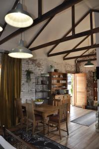 a dining room with a wooden table and chairs at SOUSIE'S RUSTIC STAY in Polokwane +8 photos