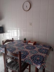 a room with a table with a clock on the wall at Casa Oskar in Avilés