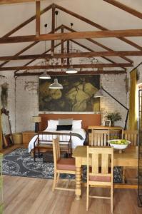 a room with a bed and a table and chairs at SOUSIE'S RUSTIC STAY in Polokwane