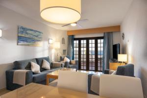 a living room with a couch and a table at Ona Las Rosas in Puerto de Santiago