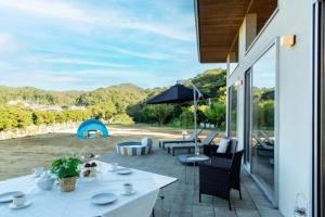 a patio with a table and chairs and a view at The SATOYAMA HILLS FK1 in Futtsu
