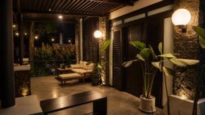 a patio with a couch and a chair and a table at The Haven 3BR Private Pool Lembang in Tegalharendong
