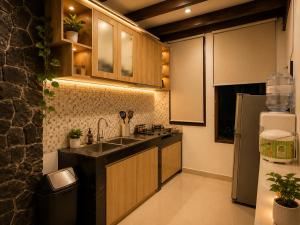 a kitchen with a sink and a refrigerator at The Haven 3BR Private Pool Lembang in Tegalharendong
