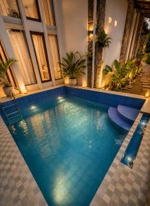a swimming pool with blue water in a building at The Haven 3BR Private Pool Lembang in Tegalharendong +8 photos