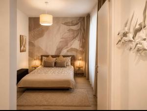 a bedroom with a bed with two pillows on it at Apartment Vitale in Bologna