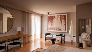 a living room with a table and chairs and a mirror at Villa Paola in Tropea