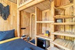 a bedroom with a bed in a wooden cabin at Mare Eco Bungalows - Kids & Family friendly in Kuta Lombok