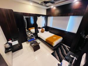 a small bedroom with a bed and a tv at Hotel The Five Star Inn in Muzaffarpur