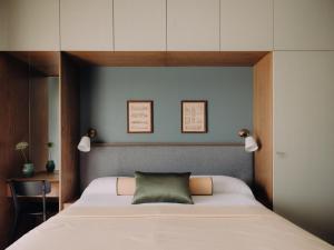 a bedroom with a bed with a green pillow on it at Longchamps l Zamalek l Boutique Hotel with Breakfast in Cairo