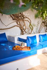 a tray of food sitting on top of a blue bench at Dar D'art Luz Galerie Boutique Guest house in Al Ghar