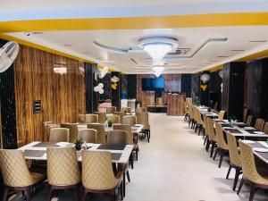 a row of tables and chairs in a restaurant at Hotel The Five Star Inn in Muzaffarpur