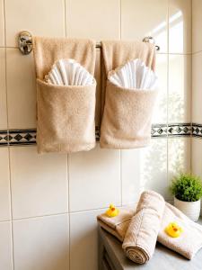 a bathroom with three towels and two rubber ducks on a counter at Lange Hans Rennsteig in Oberschönau +14 photos