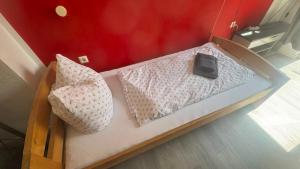 a model of a bed with a cell phone on it at Hotel und Gaststätte zum Grafenwall in Recklinghausen