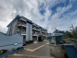 a building with balconies on the side of it at Hotel Dreamland in Kodaikānāl