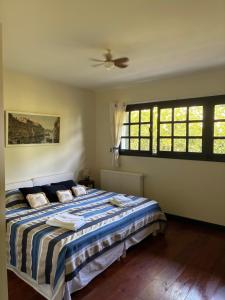 a bedroom with a bed and a ceiling fan at A la Colline de la bergerie in Cambo-les-Bains