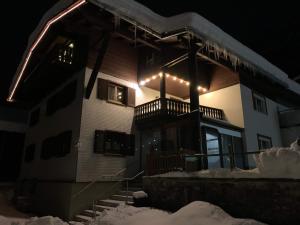 a building with lights on it in the snow at Ferienhaus "frainerei" in Klösterle