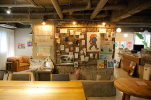 a restaurant with a brick wall with posters on it at Chuncheon Diary Stay in Chuncheon