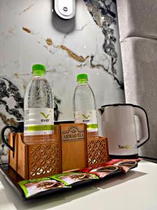 two bottles of water are sitting on a tray at Qadim Hotel in Samarkand