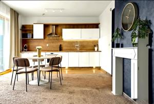 a kitchen with a table and chairs in a room at Donovaly Residence Apartment 111 in Donovaly