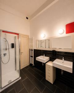 a bathroom with two sinks and a shower at Mars41 B&B in Bologna +65 photos