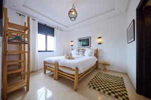 a bedroom with a bed and a ladder in it at Dar D'art Luz Galerie Boutique Guest house in Al Ghar +80 photos