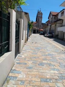 a cobblestone street in a town with a building at Hana Private Home in Pogradec