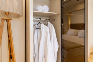 a closet with white towels and a bed at Premium Pyramids BoutiQue With Rooftop Access in Cairo