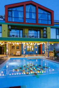 a large swimming pool in front of a building at Boutique Hotel Casa Art in Oreshak