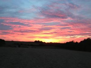 a sunset in a field with the sky at The Chilterns View in Wallingford +1 photo
